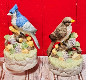 lot 385 image: Two Original Art Marks Wind-Up Music Boxes WBirds Settled on Limb & Music Box Plays Oh What a Beautiful Morning