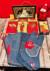 lot 390 image: Christmas Placemats, Denim Wrangler Christmas Stockings, Napkins and Holder, Along With Other Assorted Christmas Themed Items.