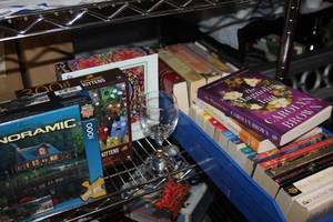 lot 19 image: Cozy Night In, Generious Lot of Books and a few Puzzles along with a wine glass