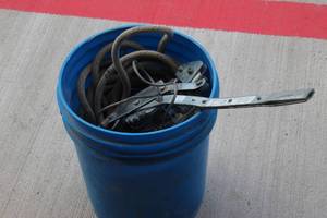 lot 96 image: Come a long, Length of Rope and Various Hardware Pieces in Bucket as shown in photos