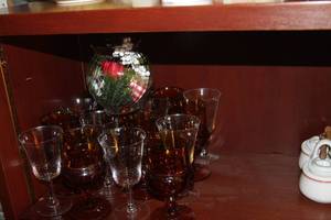 lot 118 image: Set of 12, 6 Amber Thumbprint and 6 clear crystal Cordial wine glasses and a Jeanette Swirl dish Decorated and lit.