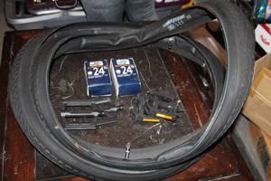 lot 123 image: New Bicycle parts, 26 in wheels and tubes, 24 inch tubes, and two sets of pedals