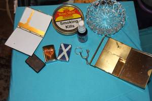 lot 156 image: 3 Zippo and Zippo Style Lighters, Crystal AshtrayCandy Dish, Vintage Tobaco Tin, and Two Vintage Cigarette Cases as shown