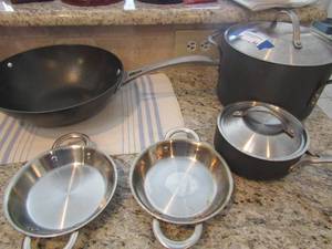 lot 44 image: Lot of Cephalon 6 qt stock pot, wok skillet 10, 1 qt stock pot, 2 handled 6 casserole dish