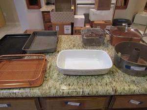lot 78 image: copper chef pan with lid, white glass casserole dish, various bake ware cookie sheets, copper basket with flat pan under