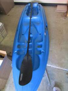 lot 12 image: Life time kayak Blue 1 seater comes with dbl. end paddle, used but lots of life left, Perfect for your spouce approx. 95 long
