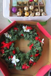 lot 366 image: clear tub half full of various kinds of Christmas tree bulbs for dcor, also a red and white flower door wreath in own box