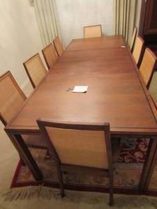 lot 333 image: Vintage Lane furniture dining table with 2 leafs 96 L 42W  28 H and 9 chairs total 2 of which are captain chairs, 2 chairs have been redone with pink material on seated area all have wicker backs. Size of leafs per is 20 41