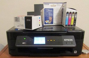 lot 399 image: Epson printer with new packs of ink qty 2, comes with a small wooden 1 drawer storage ben, 1 used pack of paper works as I just unplugged.