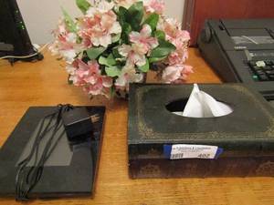 lot 402 image: book napkin holder,  alarm clock, small vase with flowers