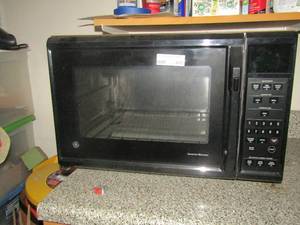lot 447 image: GE microwave Bran new has original paperwork inside