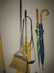 lot 450 image: Yard items, rakes, brooms, umbrellas, rain coat, yard ho