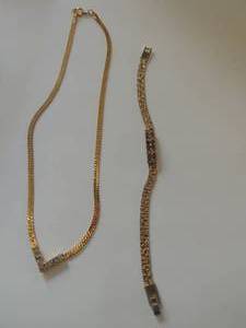 lot 159 image: 1 nugget style bejeweled bracelet and one chevron faux diamond gold necklace