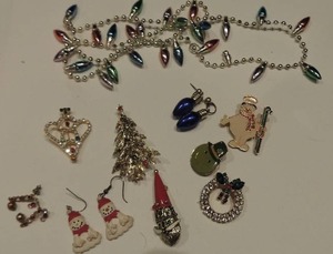 lot 189 image: 3 christmas earrings, 4 christmas pins, 1 Christmas light necklaces, 1 smily face shamrock pin