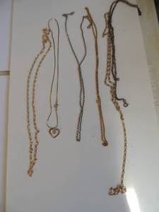 lot 220 image: 6 gold chains one with heart drop