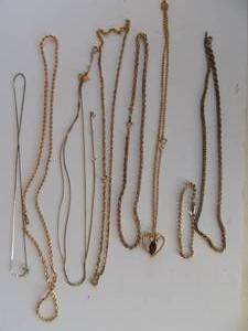 lot 217 image: 7 gold chains one with hear drop and faux diamond bracelet