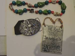 lot 255 image: rock necklace, cross belt buckle, and small hanging sign