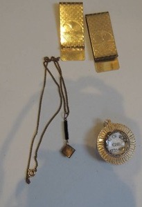 lot 226 image: tennis money clip x 2, king of rock Elvis spinning necklace drop, black and gold necklace