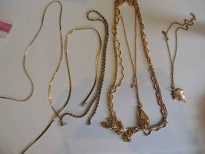 lot 236 image: 4 chains 1 with leaf drop a one necklace that consists of 3 chains in one.