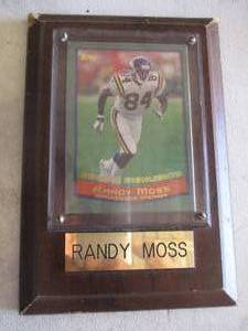 lot 13 image: TOPPS-Season Highlights - Randy Moss # 84 Minnesota Vikings Collectors Card Incased On Wooden Plaque