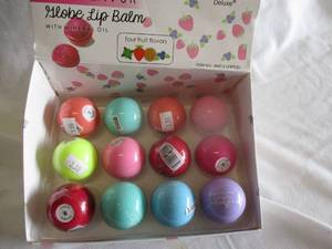 lot 98 image: 12-Italia Deluxe- Sweet Flavor Globe Lip Balm With Mineral Oil-Mixed Flavors- In Counter Display Box. Note 12 x Money