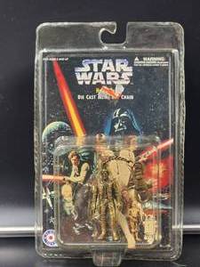lot 82 image: 1997 Star Wars Han Solo metal keychain in package