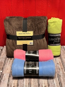 lot 143 image: 55 x 70 Luvtex Micro Velvet Quilted Throw &amp Three 50 x 60 Fleece Throws