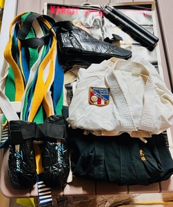 lot 245 image: Martial Arts Gear - Including Three Ghis (Two White &amp One Black), Sparring Pads, Assortment of Belts, Nunchucks, &amp Karate Strick Points Poster