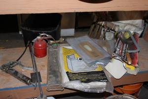 lot 41 image: Grease Gun, Oil Can, Wet Vac bags, and other vacuum bags also a miter block and Hacksaw