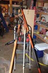 lot 55 image: Craftsman Electric Chain saw, no blade, and Poles saws as shown (Ladder not included)