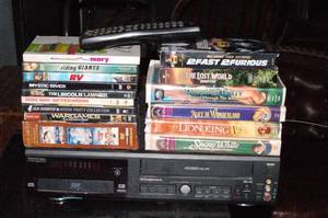 lot 278 image: Phillips DVDVHS Player with remote tested plays   with Selection of DVDs and VHS movies ..Titles as shown in pictures
