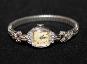 lot 201 image: Bulova 23 (L9) 10KT rolled gold and diamond watch face with diamond adorned flexible watch band. 6 diamonds total. Diamonds tested.