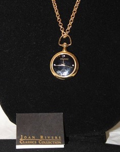 lot 204 image: Signed Joan Rivers quartz hanging watch pendant with 4 diamond markers on a 30L gold tone chain. Marked with hang tag and on watch. With booklet.