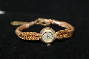 lot 205 image: 14K yellow gold antique Jaccard St. Louis (Mermod Jaccard, Swiss, approx. 1906) branded watch and 14K yellow gold flexible watch band.