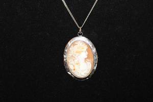lot 188 image: 10K White Gold antique framed Conch Shell cameo. Marked 10K GLP CO (George L. Paine Company, North Attleboro, Mass ca. 1909-1922). 2L on a 12K White Gold Filled 18L chain.