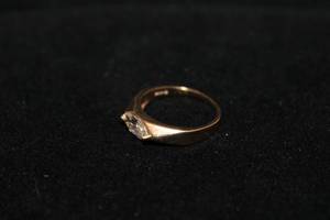 lot 191 image: 14K yellow gold Plumb ring with East-West white bezel set stone. Marked 14K P (Plumb). Size 7
