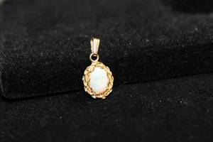 lot 195 image: 14K yellow gold Opal pendant. Marked 14K. Approx .75L