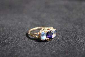 lot 197 image: 14K yellow gold Plumb Sapphire and Blue Topaz ring. Marked P14K CZ DO (QVC Diamonique). Size 7.5. Gems tested