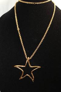 lot 210 image: Signed Givenchy opera length 34L continuous necklace with star pendant. Marked Givenchy