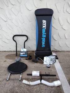 lot 218 image: Total Gym Exercise Machine with unopened DVDs