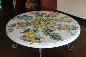 lot 10 image: Clay tabletop with fruit and floral motif on crackled white background -Table base included - 44D x 30H - Bldg. J