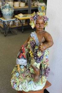 lot 3 image: Adorable grape-adorned child with rooster garden statuary