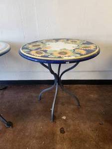 lot 85 image: Round lava and clay tabletop with sunflowers on cobalt blue crackled white background -Table base included - 29D x 30H - Bldg. J