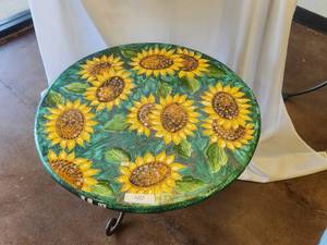 lot 40 image: Round lava and clay tabletop with sunflowers on green background -Table base included - 28D x 19H - Bldg. J