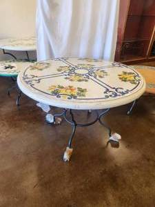 lot 90 image: Round clay tabletop signed by artist showcasing various fruits like grapes, oranges, lemons, and pomegranates. -Table base included - 47D x 30H - Bldg. J