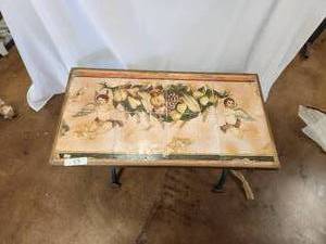 lot 53 image: Rustic hand painted tiles depicting Angels and fruits makes the perfect tabletop for this fold out galvanized iron base - can also be hung on the wall - 14 x 36 - Bldg. J
