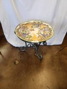 lot 75 image: Grapes and more grapes are the motif on this hand painted ceramic platter (20D) that can double as a striking piece of wall art - sits on a galvanized table base - Bldg. J