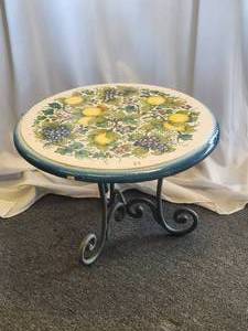 lot 88 image: Clay tabletop adorned in hand painted grapes, lemons, and flowers set against a crackled off-white background (18 x 26). Iron base included