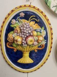 lot 109 image: Oval shaped wall art of raised depiction of fruit and flowers in a basket, set against a cobalt blue background -