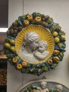 lot 129 image: Large and ornate piece of wall art depicting Madonna and baby with garland of pinecones and fruits adorning the edge
